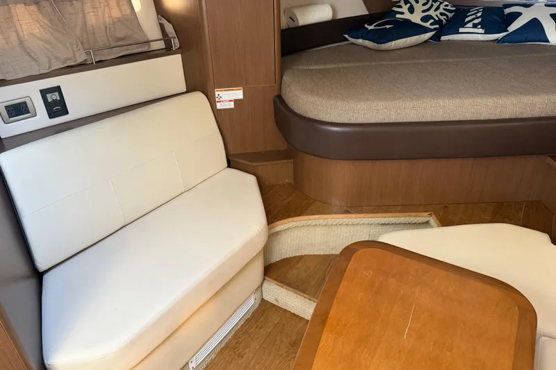 Slide: The Image of Interior of 2018 Sea Ray 350 Sundancer with seating and bed, featuring modern design. - 44