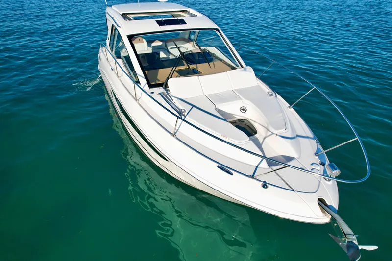 Slide: The Image of 2018 Sea Ray 350 DAC boat on clear blue water. - 5