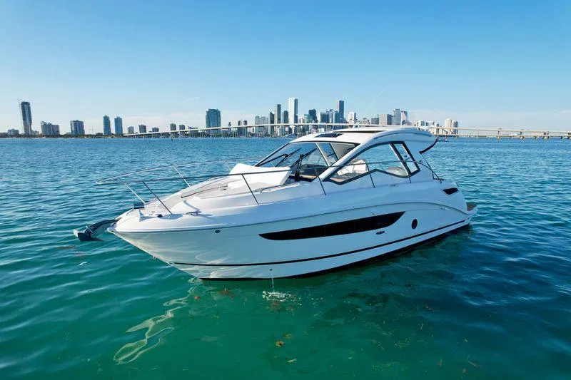 Slide: The Image of 2018 Sea Ray 350 DAC yacht on clear water with city skyline in background. - 7