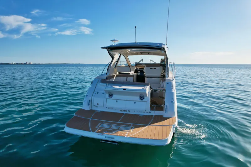 Slide: The Image of 2018 Sea Ray 350 DAC yacht on calm ocean waters, rear view. - 8