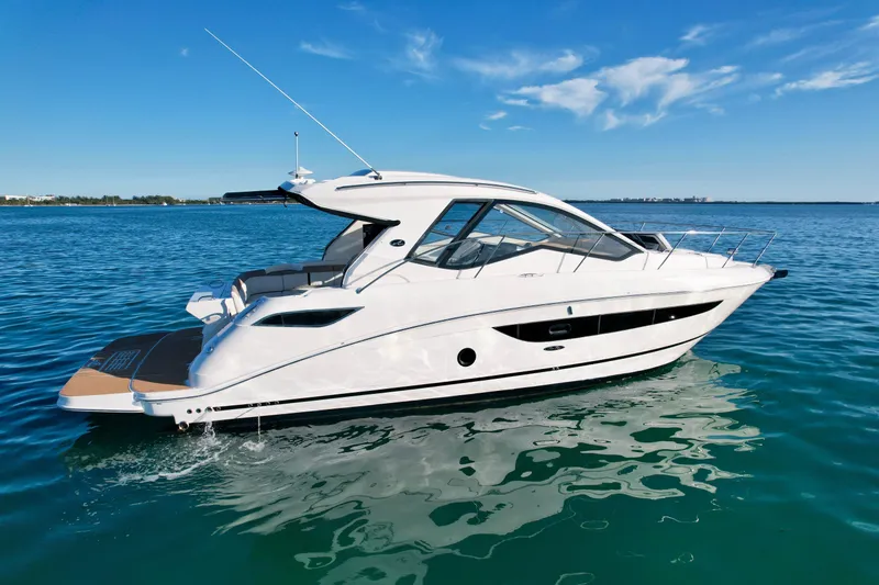 Slide: The Image of 2018 Sea Ray 350 DAC yacht cruising on clear blue water. - 9
