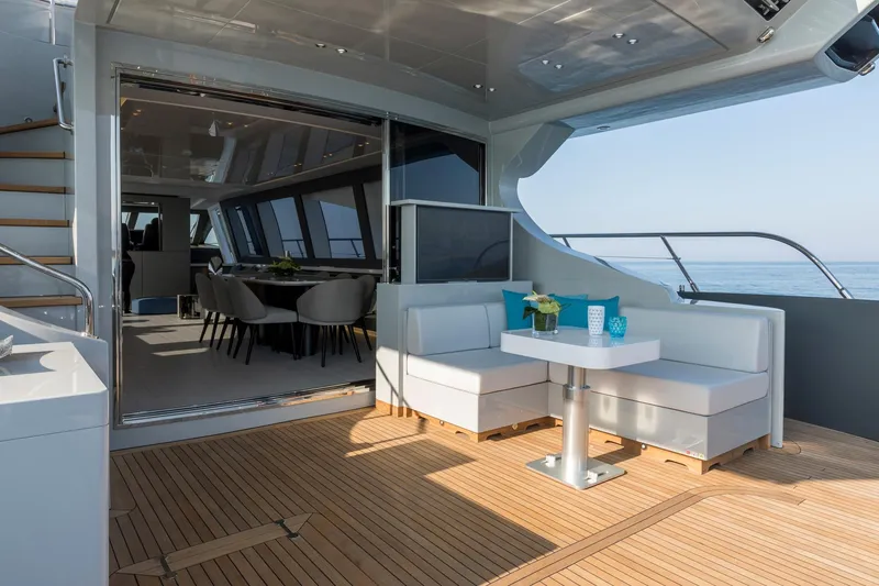 Slide: The Image of Luxurious 2020 Mangusta 110 Open yacht deck with plush seating and ocean view. - 10