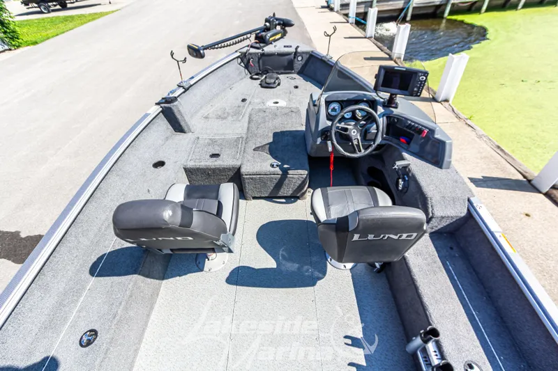 Slide: The Image of 2016 Lund 1675 Impact XS SS boat interior with steering console and seating. - 12