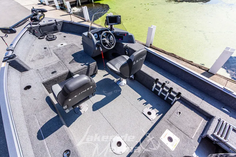 Slide: The Image of 2016 Lund 1675 Impact XS SS boat interior with seating and control panel. - 13