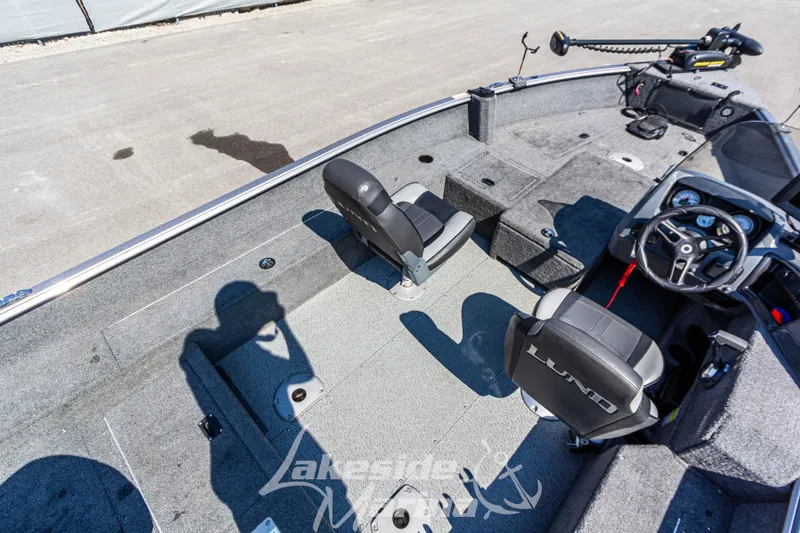 Slide: The Image of 2016 Lund 1675 Impact XS SS boat interior with seating and steering console. - 14