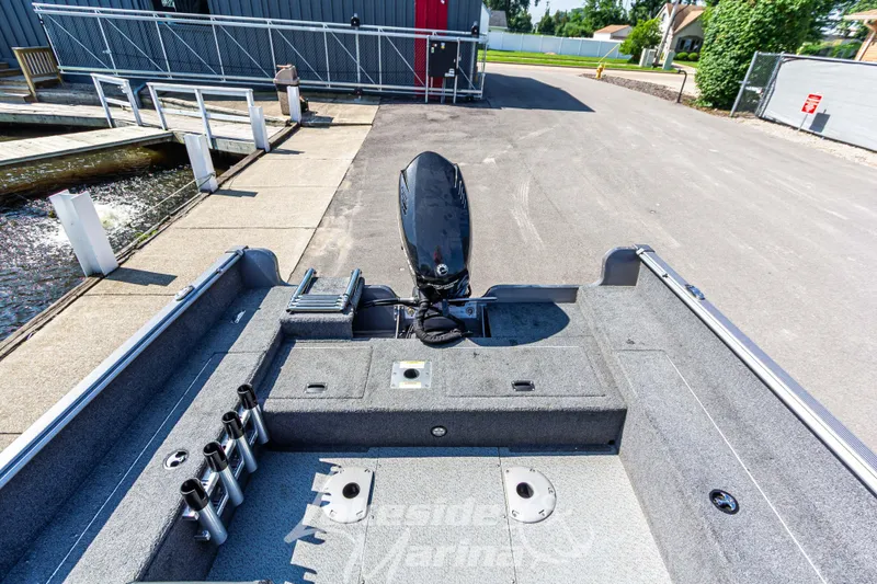 Slide: The Image of 2016 Lund 1675 Impact XS SS boat at marina dock, rear view. - 15