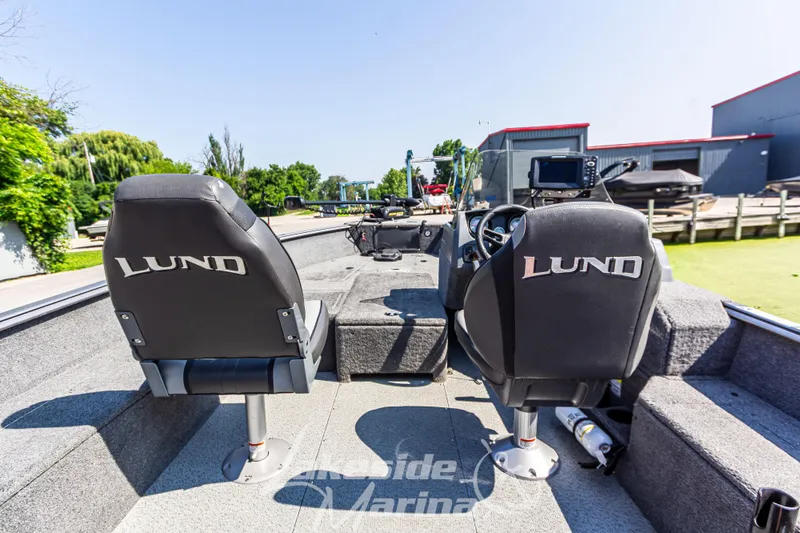 Slide: The Image of 2016 Lund 1675 Impact XS SS boat interior with two branded seats and control panel. - 17