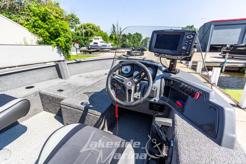 Slide: The Image of 2016 Lund 1675 Impact XS SS boat interior with steering wheel and control panel. - 18