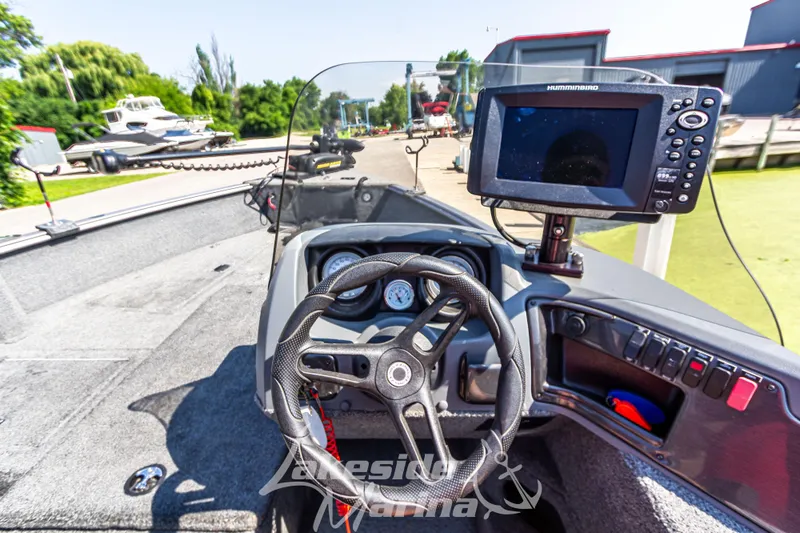 Slide: The Image of 2016 Lund 1675 Impact XS SS boat dashboard with steering wheel and navigation system. - 20