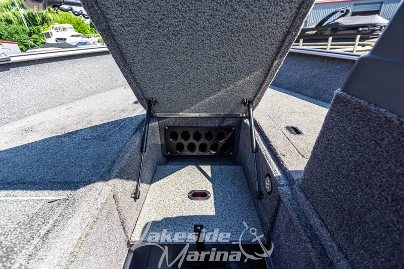 Slide: The Image of 2016 Lund 1675 Impact XS SS boat interior storage compartment open at Lakeside Marina. - 26