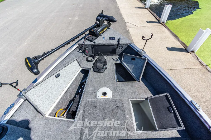 Slide: The Image of 2016 Lund 1675 Impact XS SS boat interior with storage compartments and trolling motor. - 28