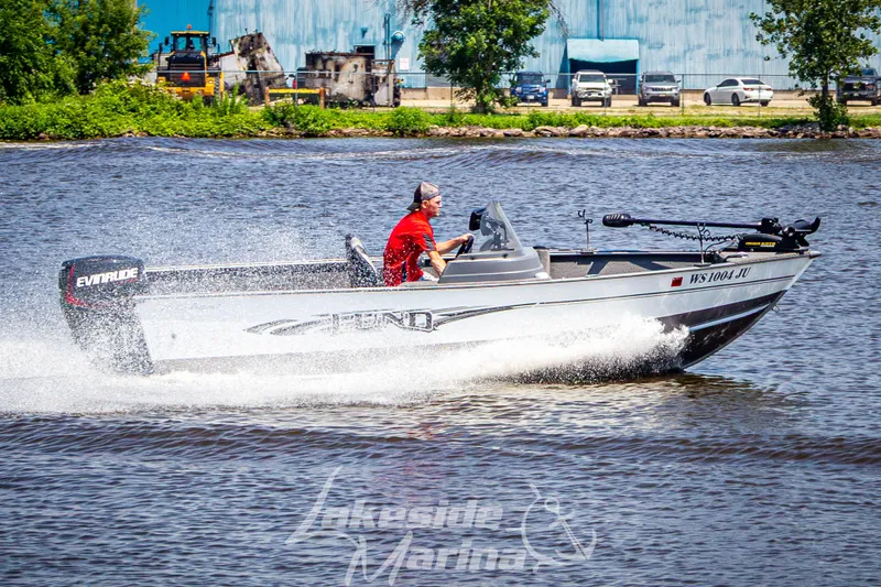 Slide: The Image of 2016 Lund 1675 Impact XS SS boat speeding on a lake with Evinrude motor. - 30