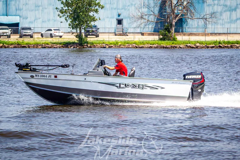 Slide: The Image of 2016 Lund 1675 Impact XS SS boat cruising on a river with a driver. - 31