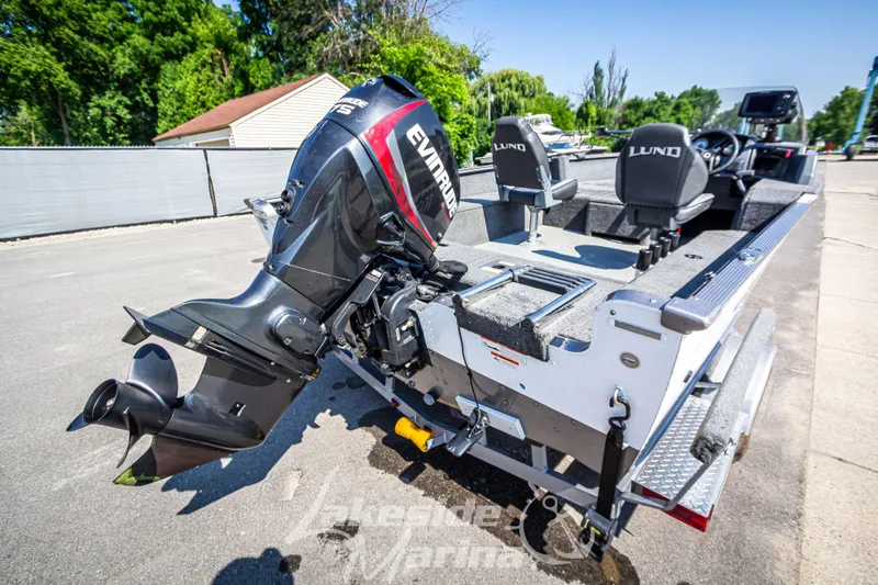 Slide: The Image of 2016 Lund 1675 Impact XS SS boat with Evinrude motor, parked outdoors. - 4