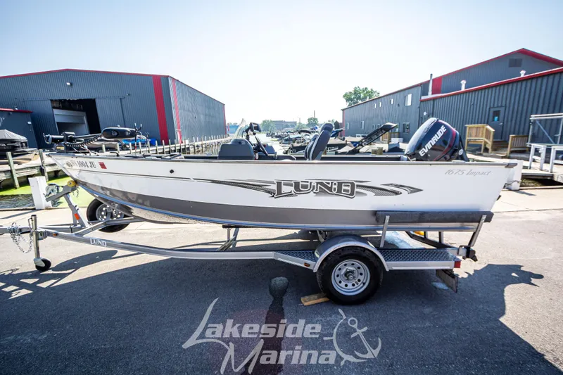 Slide: The Image of 2016 Lund 1675 Impact XS SS boat on trailer at marina. - 8