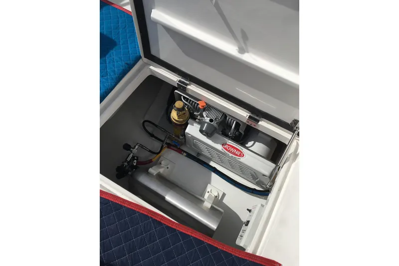 Slide: The Image of Engine compartment of 2017 Intrepid 475 Sport Yacht, featuring a Brownie's compressor. - 12