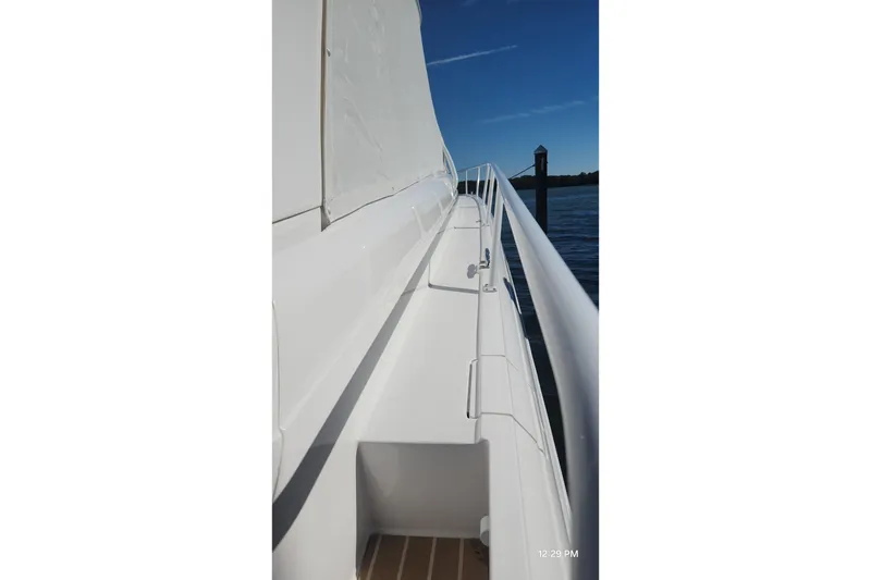 Slide: The Image of Side view of a 2017 Intrepid 475 Sport Yacht, showcasing sleek white design. - 13