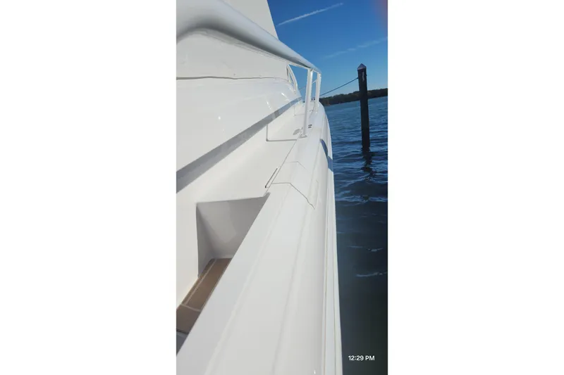 Slide: The Image of Side view of a 2017 Intrepid 475 Sport Yacht docked by the water. - 14