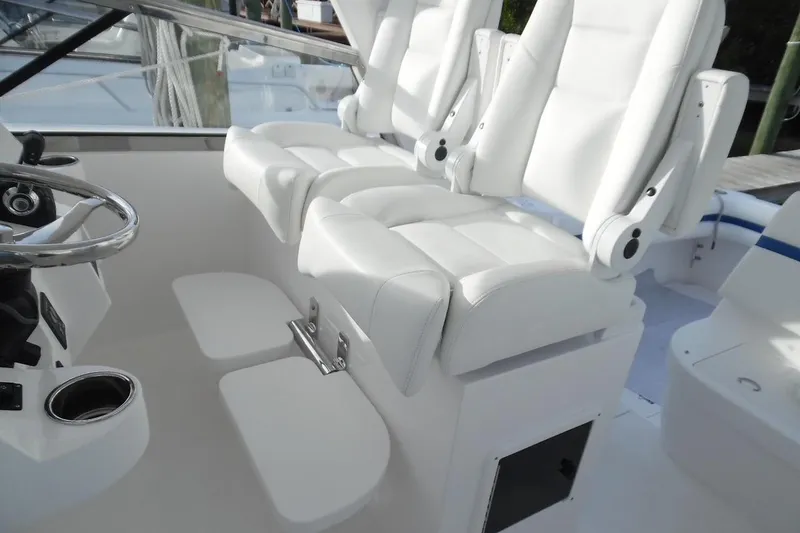 Slide: The Image of Luxury seating on 2017 Intrepid 475 Sport Yacht, featuring white leather captain's chairs. - 17