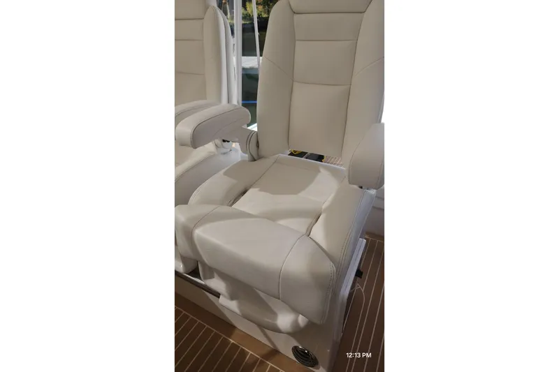 Slide: The Image of Luxurious seating on 2017 Intrepid 475 Sport Yacht, featuring plush white upholstery. - 18