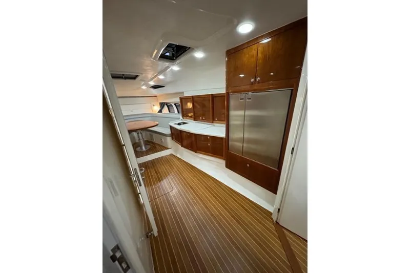 Slide: The Image of Interior of 2017 Intrepid 475 Sport Yacht with wood flooring and modern cabinetry. - 20