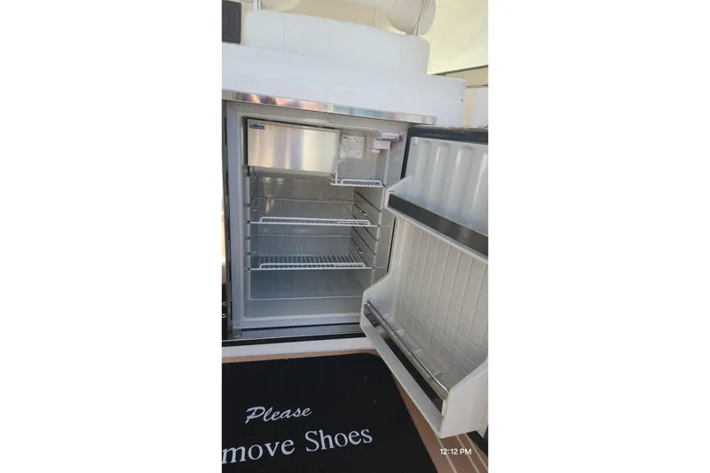 Slide: The Image of Open refrigerator on 2017 Intrepid 475 Sport Yacht with "Please Remove Shoes" mat. - 25