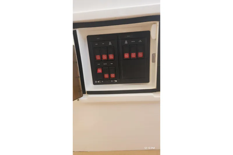 Slide: The Image of Control panel of a 2017 Intrepid 475 Sport Yacht with labeled switches. - 27