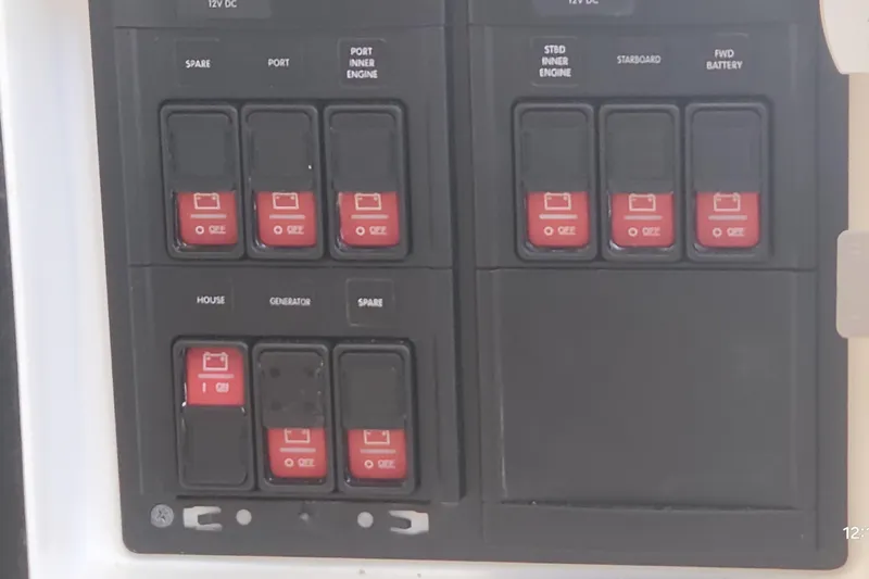 Slide: The Image of Control panel of a 2017 Intrepid 475 Sport Yacht with labeled switches. - 28