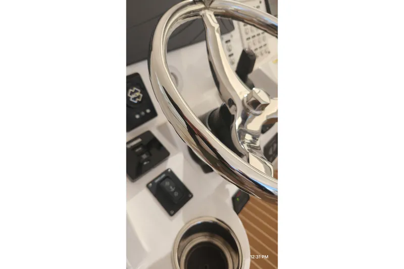 Slide: The Image of Steering wheel of a 2017 Intrepid 475 Sport Yacht, showcasing control panel details. - 30