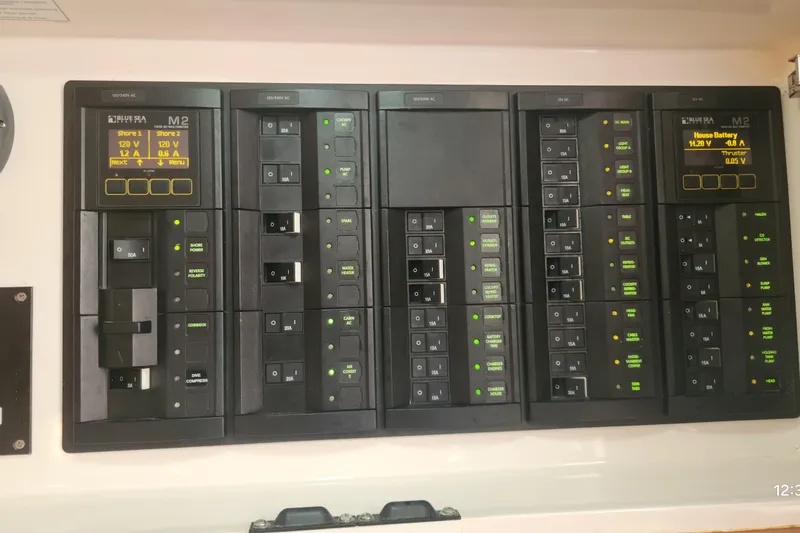 Slide: The Image of Electrical panel of a 2017 Intrepid 475 Sport Yacht with various switches and indicators. - 36