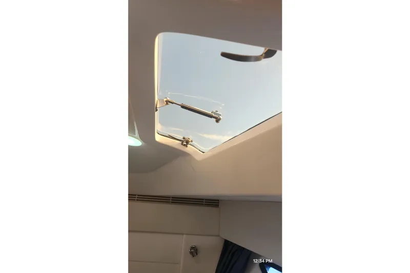 Slide: The Image of Skylight view from 2017 Intrepid 475 Sport Yacht interior, showcasing clear sky. - 38