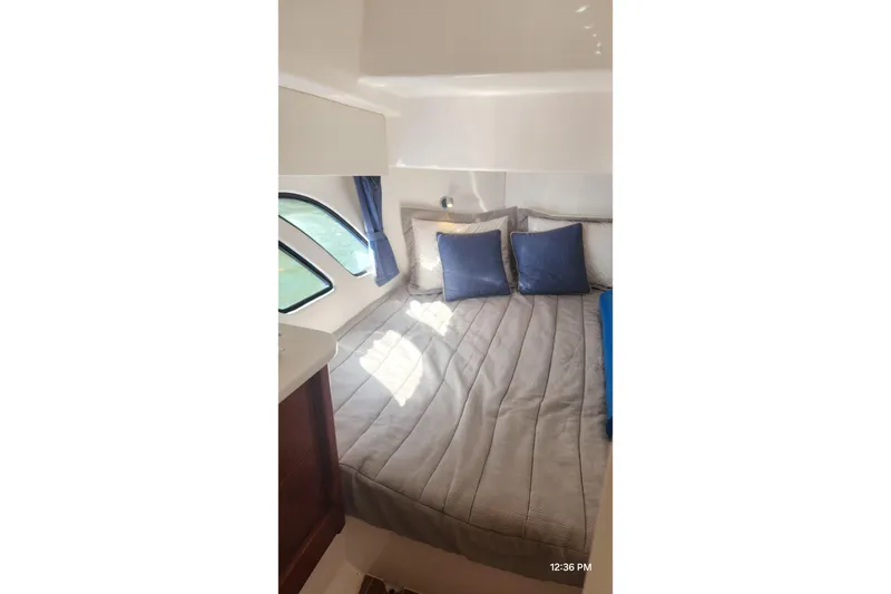 Slide: The Image of Luxurious cabin interior of 2017 Intrepid 475 Sport Yacht with cozy bedding and natural light. - 42