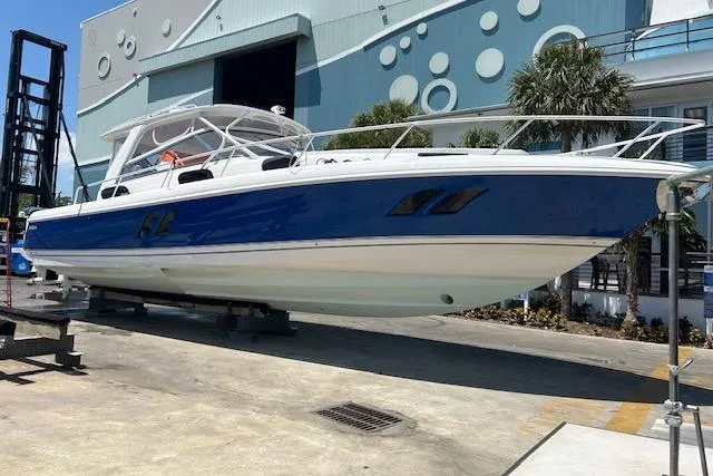 Slide: The Image of 2017 Intrepid 475 Sport Yacht in dry dock, blue and white hull, modern design. - 5