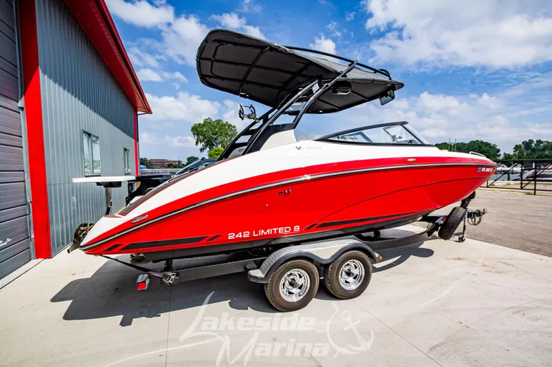Slide: The Image of 2016 Yamaha Boats 242 Limited S E-Series in red on trailer at marina. - 3