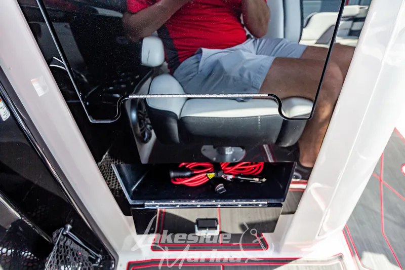 Slide: The Image of 2016 Yamaha Boats 242 Limited S E-Series interior with storage compartment and accessories. - 30