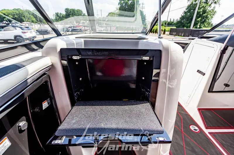 Slide: The Image of 2016 Yamaha Boats 242 Limited S E-Series interior storage compartment open. - 31