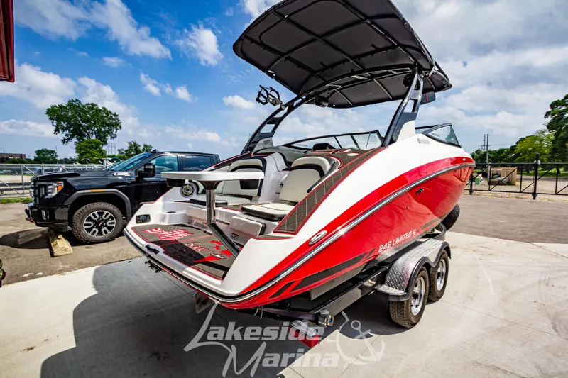 Slide: The Image of 2016 Yamaha Boats 242 Limited S E-Series on trailer, parked outdoors under blue sky. - 4