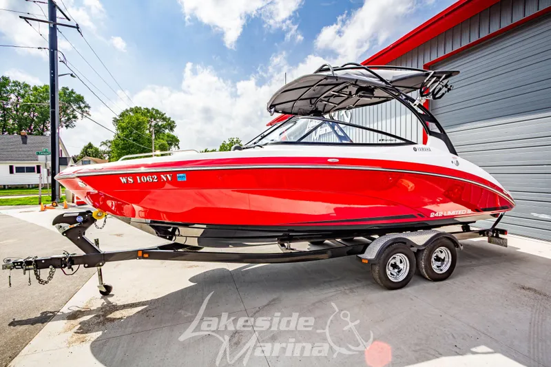 Slide: The Image of 2016 Yamaha Boats 242 Limited S E-Series in vibrant red on trailer. - 8
