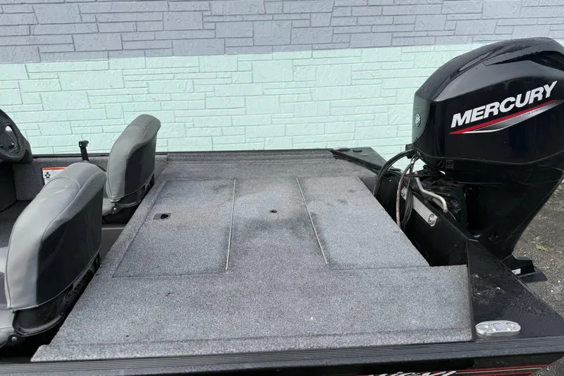 Slide: The Image of 2022 Bass Tracker Classic XL boat with Mercury engine, gray seating, and carpeted deck. - 10