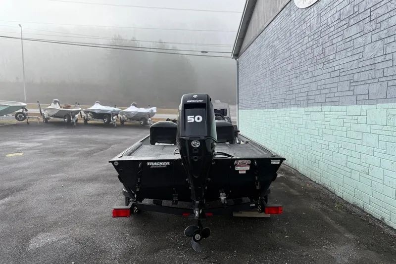 Slide: The Image of 2022 Bass Tracker Classic XL boat with Mercury 50 engine in a foggy outdoor setting. - 12