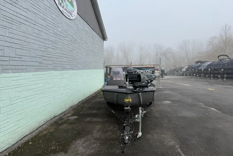 Slide: The Image of 2022 Bass Tracker Classic XL boat parked outside a marine dealership on a foggy day. - 3
