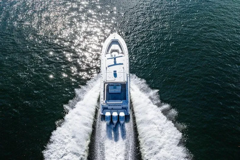 Slide: The Image of 2024 HCB 42 Lujo boat cruising on open water, aerial view. - 13