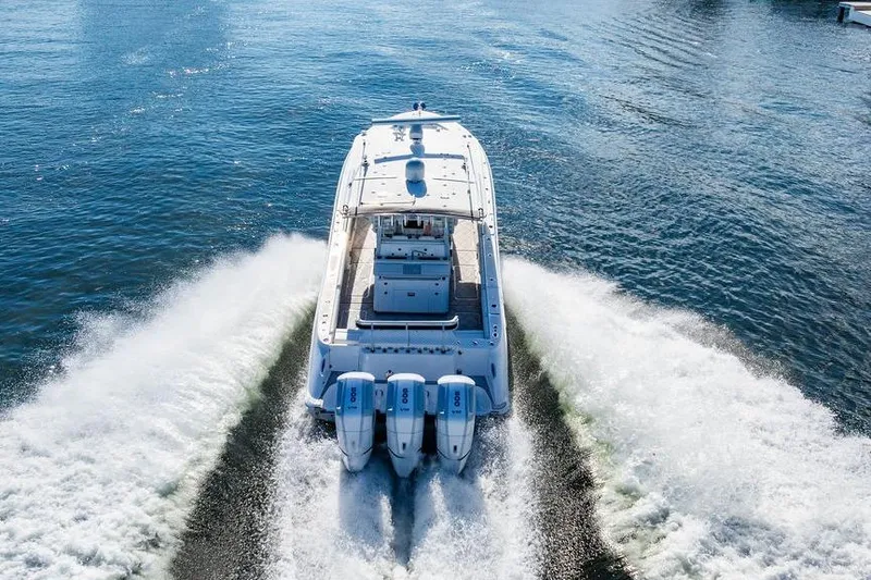 Slide: The Image of 2024 HCB 42 Lujo boat cruising on open water with powerful engines. - 14