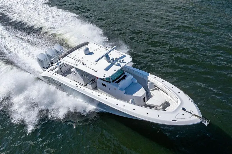 Slide: The Image of 2024 HCB 42 Lujo boat cruising on open water, showcasing sleek design and powerful engines. - 27