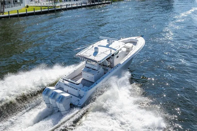 Slide: The Image of 2024 HCB 42 Lujo boat cruising on a sunny waterway, showcasing powerful engines. - 32