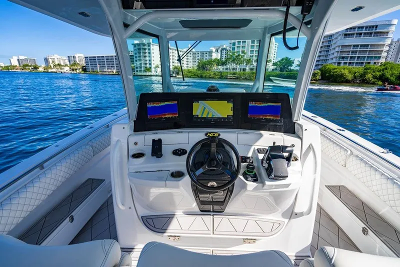 Slide: The Image of Helm of 2024 HCB 42 Lujo boat with modern navigation displays on a sunny day. - 34