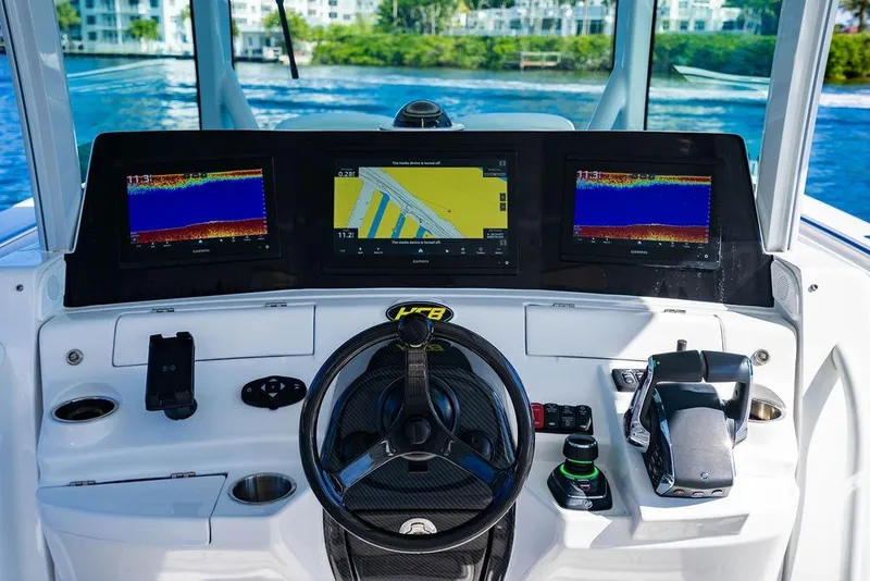 Slide: The Image of 2024 HCB 42 Lujo boat dashboard with advanced navigation displays and controls. - 35