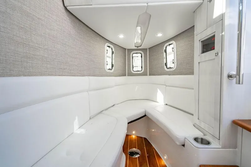 Slide: The Image of Luxurious interior of 2024 HCB 42 Lujo boat with white seating and wood flooring. - 39
