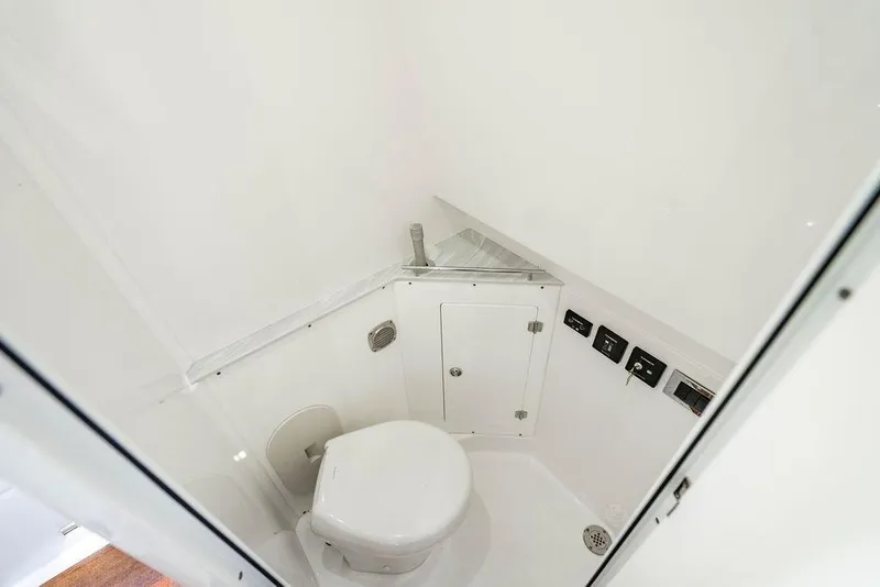 Slide: The Image of 2024 HCB 42 Lujo boat bathroom with modern fixtures and white interior. - 42
