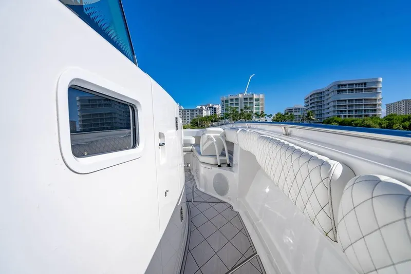 Slide: The Image of 2024 HCB 42 Lujo yacht deck with luxurious seating, cityscape in background. - 56